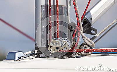 Pulley and rope system at the base of the mast for sail installing on board the yacht Stock Photo