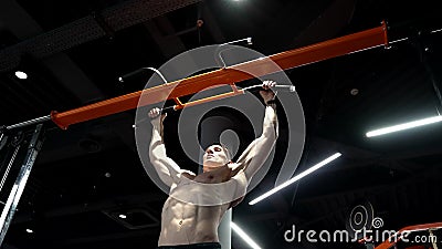 Pullup. Strong Man Practicing Pullup in Sport Gym. Man Do Pullup