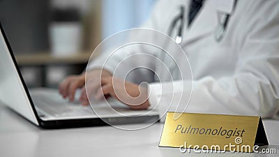 Pulmonologist prescribing medication to treat asthma, filling out medical forms Stock Photo