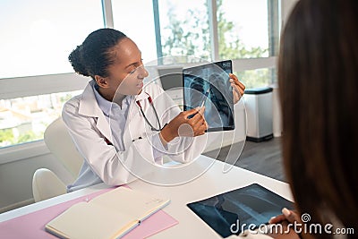 Pulmonologist showing x-ray picture and explaining diagnosis Stock Photo