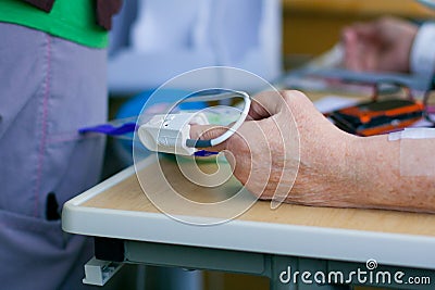 Pulse oximeter on patient's fingertip Stock Photo