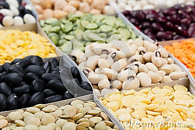 Pulses food background, assortment - legume, kidney beans, peas, lentils in square cells macro. Stock Photo