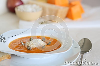 Pumkin cream soup with its ingridients in the background Stock Photo