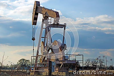 Pump jack pumping oil from the earth Stock Photo