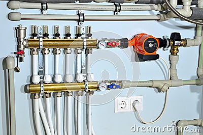 Pump with a thermometer for a water underfloor heating system at home. Servo, sensors and temperature control. Stock Photo