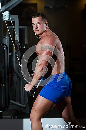 Pumped man pulling weight Stock Photo