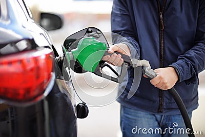 Pumping gas at gas pump Stock Photo