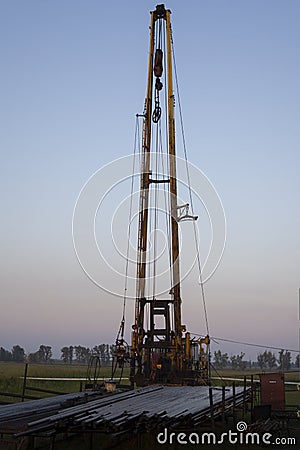 The pumping units and well workover operation. Oil Pump Jack Sucker Rod Beam and Workover Rig Working on Oil Well. Oil and gas Stock Photo