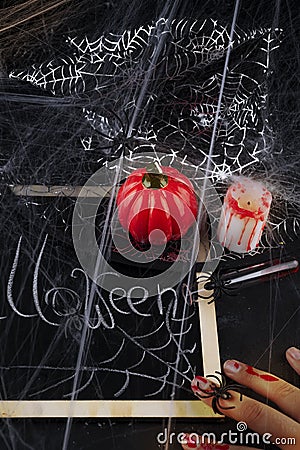 Pumpkin, candle and a long glass with a red cocktail Stock Photo