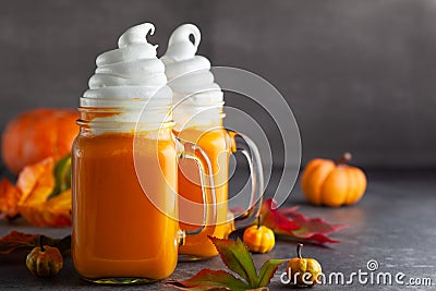 Pumpkin cocktail with whipped cream in glass mugs. Pumpkin autumn drink for Halloween or Thanksgiving Stock Photo