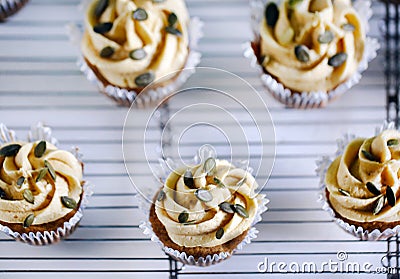 Pumpkin cupcake with buttercream and pumpkin seeds, fresh baking Stock Photo