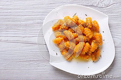 Pumpkin gnocchi with sauce and spices, horizontal top view Stock Photo