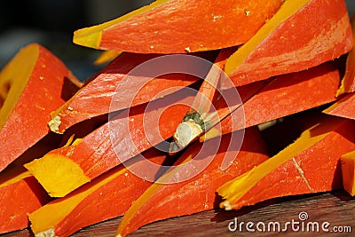 Pumpkin Hokkaido hollowed and cut in wedges and arranged on a heap. Stock Photo