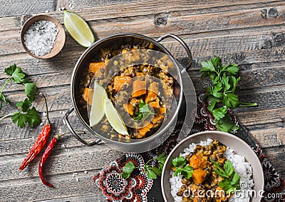 Pumpkin lentil curry and rice on a wooden table, top view. Indian vegetarian food Stock Photo