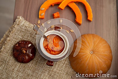 Pumpkin milk soup in a pot, close-up Stock Photo