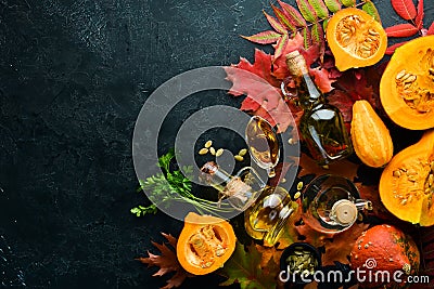 Pumpkin oil and pumpkins. Autumn vegetables. . Stock Photo