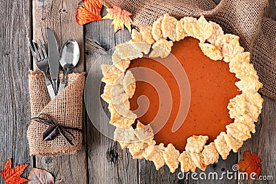 Pumpkin pie with autumn leaf pastry design, overhead table scene Stock Photo