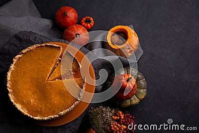 pumpkin pie and pumpkin lanterns on black background, top view, halloween Stock Photo