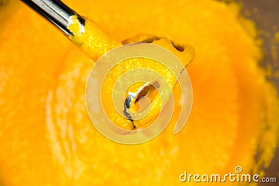 Pumpkin puree with blender in bowl closeup. Fall recipe. Cooking mashed pumpkin Stock Photo