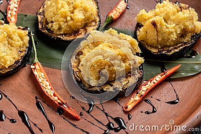 Pumpkin puree is laid out on grilled eggplant. Stock Photo