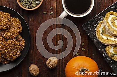 Pumpkin Roll and pumpkin cookies on the wooden table with cup of coffee. Holiday composition Stock Photo