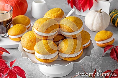 Pumpkin sandwich cookies with cream cheese on a gray concrete bsckground. Spicy autumn dessert. Copy space Stock Photo