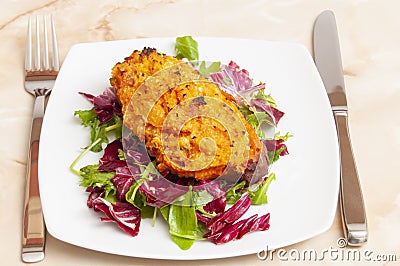 Pumpkin sandwich on a salad base with white plate, fork and knife Stock Photo