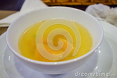 Pumpkin soup in a plate with a spoon in a restaurant Stock Photo