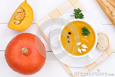 Pumpkin soup with pumpkins in bowl from above Stock Photo