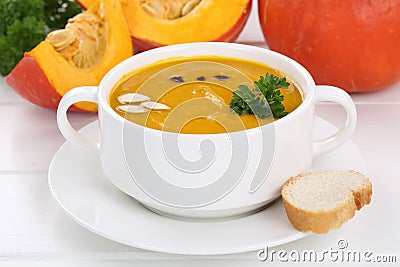 Pumpkin soup with pumpkins in bowl Stock Photo