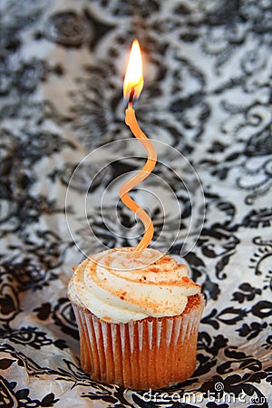 Pumpkin spice cupcake with orange wavy candle Stock Photo