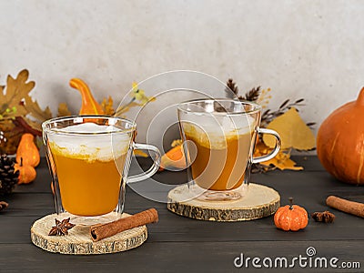 Pumpkin spice latte in glass mugs with cinnamon, nutmeg, and whipped cream. Stock Photo