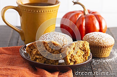 Pumpkin Spice Muffins Topped with Powdered Sugar on a Wooden Table Stock Photo