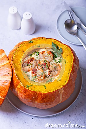 Pumpkin stuffed with shrimps and cheese, whole baked. Traditional Brazilian dish. Stock Photo
