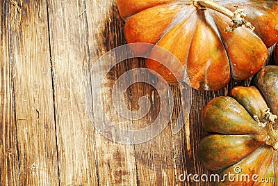 Pumpkin on wooden background. autumn still life of pumpkin on a brown wooden floor. pumpkin close-up shot from the top point Stock Photo