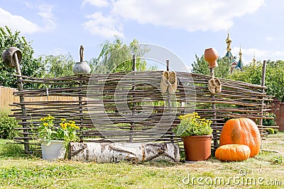 Pumpkins at wicker fence Stock Photo