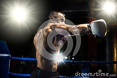 Punching boxer on boxing ring Stock Photo