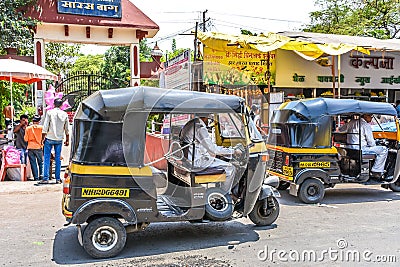 Pune , India - April 26 2015 : Man drives tricycle in front of Saras Baug. Editorial Stock Photo