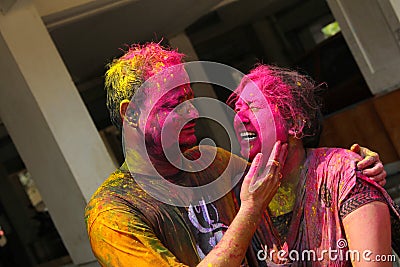 PUNE, INDIA, March 2018, Young India couple enjoy Holi and applying dry color to each other. Editorial Stock Photo