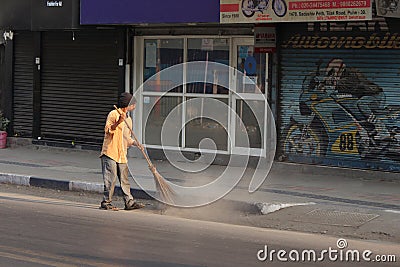 PUNE, MAHARASHTRA, INDIA, February 2019, Man clean street in the morning Editorial Stock Photo