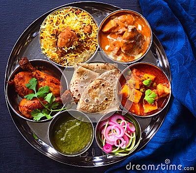 Indian non-vegetarian Meal -Butter Chicken, rajma, biryani with roti and salad Stock Photo