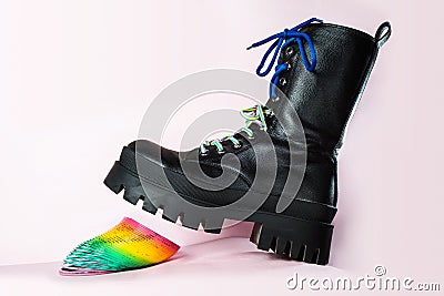 Punk youth teenage style black ankle boot crushes elastic plastic slinky toy Editorial Stock Photo