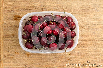 Punnet filled with ripe red summer cherries Stock Photo