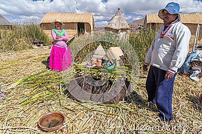 Puno, Peru - circa June 2015: Family at Uros floating island and village on Lake Titicaca near Puno, Peru Editorial Stock Photo