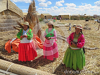 Puno, Peru - circa June 2015: Women singing at Uros floating island and village on Lake Titicaca near Puno, Peru Editorial Stock Photo