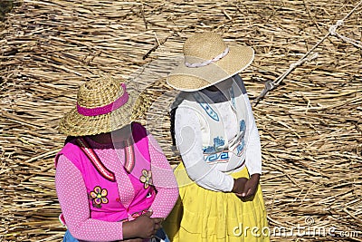 Lake Titicaca with Totoras Island with women from the Uros culture with their typical clothes and straw hats Editorial Stock Photo