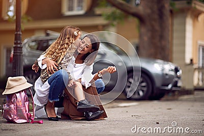 Pupil girl and mother after first day of school is over Stock Photo