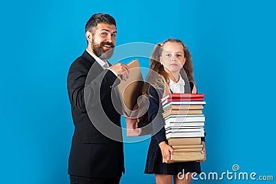 Pupil girl with pile of books ready to school. Hard to study. Father preparing backpack with school supplies for Stock Photo