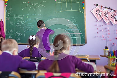 Pupil works with the board in the classroom Editorial Stock Photo