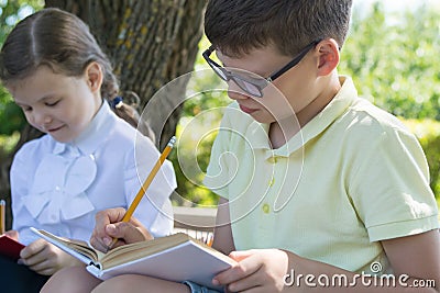 Pupils boy and girl are engaged in an outdoor lesson Stock Photo